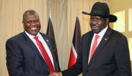 FILE PHOTO: South Sudan's President Salva Kiir shakes hands with ex-vice president and former rebel leader Riek Machar during their meeting in Juba, South Sudan, October 19, 2019. REUTERS/Jok Solomun/File Photo