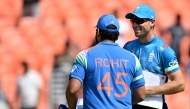 India's captain Rohit Sharma (L) and England's captain Jos Buttler interact during toss at the start of the third one-day international (ODI) cricket match between India and England at the Narendra Modi Stadium in Ahmedabad on February 12, 2025. (Photo by Sajjad HUSSAIN / AFP)