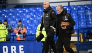 Liverpool's Dutch manager Arne Slot (L) walks on the pitch ahead of the English Premier League football match between Everton and Liverpool at Goodison Park in Liverpool, north west England on February 12, 2025. (Photo by Paul ELLIS / AFP)