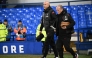 Liverpool's Dutch manager Arne Slot (L) walks on the pitch ahead of the English Premier League football match between Everton and Liverpool at Goodison Park in Liverpool, north west England on February 12, 2025. (Photo by Paul ELLIS / AFP)