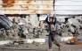 A Palestinian boy carries a container on his head in al-Mughraqa in the central Gaza Strip, on February 13, 2025. Photo by Eyad BABA / AFP