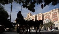 Tourists visit the town of Malaga in a horse-drawn carriage on February 10, 2025. (Photo by Jorge Guerrero / AFP)
 