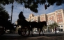 Tourists visit the town of Malaga in a horse-drawn carriage on February 10, 2025. (Photo by Jorge Guerrero / AFP)
 