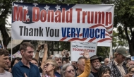 White South Africans supporting US President Donald Trump and South African and US tech billionaire Elon Musk gather in front of the US Embassy in Pretoria. (Photo by Marco Longari / AFP)