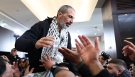 A former Palestinian prisoner is welcomed by relatives upon arriving in the occupied West Bank city of Ramallah on February 15, 2025. (Photo by Zain Jaafar / AFP)
 