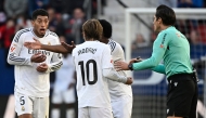 Real Madrid's English midfielder #05 Jude Bellingham reacts to being presented a red card by Spanish referee Munuera Montero during the Spanish league football match between CA Osasuna and Real Madrid CF at El Sadar Stadium in Pamplona on February 15, 2025. (Photo by ANDER GILLENEA / AFP)
