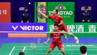 Indonesia's Siti Fadia Silva Ramadhanti (C) and Rinov Rivaldy (top) play a point during their mixed doubles match against China's Gao Jiaxuan (R) and Wu Mengying (L) at the Badminton Asia Mixed Team Championships in Qingdao, in China's eastern Shandong province on February 16, 2025. (Photo by AFP)