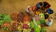 People buy vegetables at a market in Colombo on February 17, 2025. (Photo by Ishara S. KODIKARA / AFP)