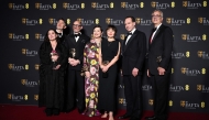 British German director Edward Berger (3L) Italian actor Isabella Rossellini (4L) and British actor Ralph Fiennes (2R) pose with the award for Best film for 