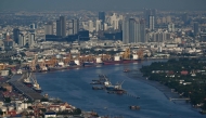 This photo taken on May 14, 2024 shows the skyline in the backdrop of the Bangkok Port as seen from the Mahanakhon Tower Observation deck in Bangkok. Photo by Lillian SUWANRUMPHA / AFP