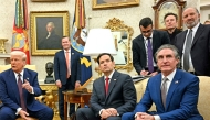 US President Donald Trump speaks with the press as he meets with unseen Indian Prime Minister Narendra Modi, alongside US Secretary of State Marco Rubio (2nd R), US Secretary of the Interior Doug Burgum (R), Elon Musk (top C) and US Secretary of Commerce nominee Howard Lutnick (top R), in the Oval Office of the White House in Washington, DC, on February 13, 2025. (Photo by Jim WATSON / AFP)
