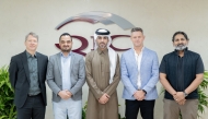 QIC Group CEO Salem Al Mannai pose for a group photo with other officials.