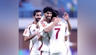 Qatar players celebrate a goal against Kyrgyzstan yesterday. 