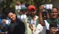 Spectators display their match tickets while waiting to enter the National Stadium in Karachi on February 19, 2025. (Photo by Rizwan Tabassum / AFP)