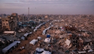 Palestinians walk past tents lining the streets amid the rubble of destroyed buildings in Jabalia, in the northern Gaza Strip on February 18, 2025. Photo by Omar AL-QATTAA / AFP