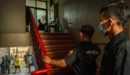 Members of the Karen Border Guard Force (BGF) carry out an inspection at a work place during a crackdown operation on illicit activity linked to scam centres in Shwe Kokko in Myanmar's eastern Myawaddy township on February 18, 2025. (Photo by AFP)
