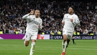 Real Madrid's French forward #09 Kylian Mbappe (C) celebrates scoring his third goal for a hat trick during the UEFA Champions League knockout phase play-off football match between Real Madrid CF and Manchester City at the Santiago Bernabeu stadium in Madrid on February 19, 2025. (Photo by OSCAR DEL POZO / AFP)
