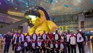 Qatar basketball team's players and officials pose for a photo prior to their departure for Astana.