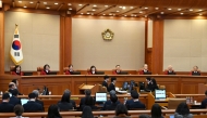 (L-R) The Constitutional Court of Korea's eight justices Chung Kye-sun, Kim Bok-hyeong, Jung Jung-mi, Lee Mi-son, Moon Hyung-bae, Kim Hyung-du, Cheong Hyung-sik and Cho Han-chang are seated in their courtroom for the trial of South Korea's impeached President Yoon Suk Yeol during the tenth hearing over his short-lived imposition of martial law at the Constitutional Court in Seoul on February 20, 2025. (Photo by SONG Kyung-Seok / POOL / AFP)