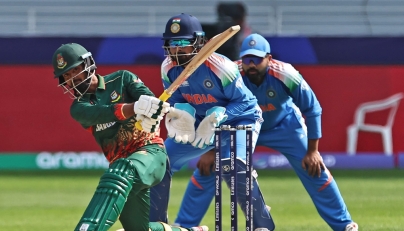 Bangladesh's Towhid Hridoy (L) plays a shot as India's wicketkeeper KL Rahul (C) watches during the ICC Champions Trophy one-day international (ODI) cricket match between Bangladesh and India at the Dubai International Stadium in Dubai on February 20, 2025. (Photo by Fadel Senna / AFP)