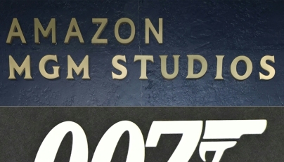 (COMBO) This combination of photographs created on February 20, 2025, shows Amazon MGM Studios logo on display at the celebrate Awards Season 2025 on January 4, 2025 (TOP) and the '007' logo on display during the press preview of the 