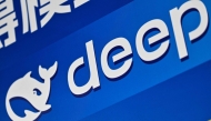 The logo of Deepseek is seen during the Global Developer Conference, organised by the Shanghai AI Industry Association, in Shanghai on February 21, 2025. (Photo by Hector RETAMAL / AFP)