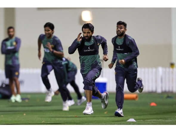 Pakistan's captain Mohammad Rizwan (front) and his teammates warm up during a practice session at the ICC Academy groud in Dubai on February 21, 2025. (Photo by Fadel Senna / AFP)