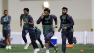 Pakistan's captain Mohammad Rizwan (front) and his teammates warm up during a practice session at the ICC Academy groud in Dubai on February 21, 2025. (Photo by Fadel Senna / AFP)