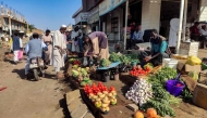 Street vendors sell their fruits and vegetables at a market in Wad Madani in Sudan's al-Jazira state on February 20, 2025. (Photo by AFP)