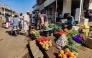 Street vendors sell their fruits and vegetables at a market in Wad Madani in Sudan's al-Jazira state on February 20, 2025. (Photo by AFP)