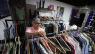 A teacher browses clothes inside a second-hand run by the Venezuelan Teachers' Federation (FVM) in Caracas, on February 17, 2025. (Photo by Pedro Mattey / AFP)
 