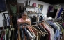 A teacher browses clothes inside a second-hand run by the Venezuelan Teachers' Federation (FVM) in Caracas, on February 17, 2025. (Photo by Pedro Mattey / AFP)
 