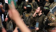 Israeli hostage Omer Shem Tov and Palestinian Hamas fighters after being released along with two others as part of the seventh hostage-prisoner exchange ,in Nuseirat in the central Gaza Strip, on February 22, 2025. (Photo by Bashar TALEB / AFP)
