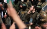 Israeli hostage Omer Shem Tov and Palestinian Hamas fighters after being released along with two others as part of the seventh hostage-prisoner exchange ,in Nuseirat in the central Gaza Strip, on February 22, 2025. (Photo by Bashar TALEB / AFP)
