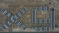 An aerial photo shows X9 electric vehicles by Chinese EV manufacturer XPeng, waiting to be loaded on a ship of the NYK line for Thailand during a ceremony in the Port of Guangzhou, China's southern Guangdong province on February 22, 2025. (Photo by Pedro Pardo / AFP)