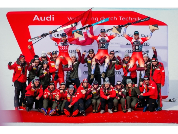 Second-placed Switzerland's Marco Odermatt, first-placed Switzerland's Franjo Von Allmen and third-placed Switzerland's Alexis Monney pose with their staff after the men's downhill event at the FIS Alpine Skiing World Cup in Crans-Montana on February 22, 2025. (Photo by maxime schmid / AFP)