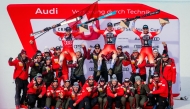 Second-placed Switzerland's Marco Odermatt, first-placed Switzerland's Franjo Von Allmen and third-placed Switzerland's Alexis Monney pose with their staff after the men's downhill event at the FIS Alpine Skiing World Cup in Crans-Montana on February 22, 2025. (Photo by maxime schmid / AFP)