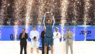 Russia's Andrey Rublev celebrates with the trophy after winning the Qatar ExxonMobil Open title yesterday. 