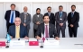 Permanent Representative of Qatar to UN Office in Geneva H E Dr. Hind Abd Al Rahman Al Muftah and others look as CRA President Engineer Ahmad Abdulla AlMuslemani (right) and ITU Radio Communication Bureau Director, Mario Mankiewicz sign the MoU. 