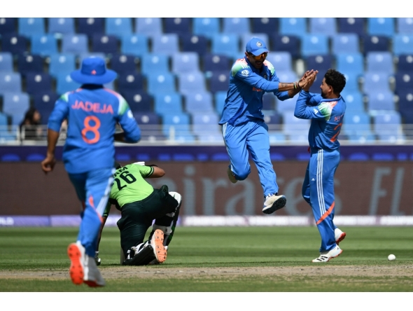 India's Axar Patel (2R) celebrates with Kuldeep Yadav (R) after taking the wicket of Pakistan's Imam-ul-Haq (2L) during the ICC Champions Trophy cricket match between Pakistan and India in Dubai on February 23, 2025. (Photo by Jewel Samad / AFP)