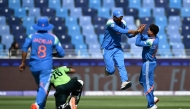 India's Axar Patel (2R) celebrates with Kuldeep Yadav (R) after taking the wicket of Pakistan's Imam-ul-Haq (2L) during the ICC Champions Trophy cricket match between Pakistan and India in Dubai on February 23, 2025. (Photo by Jewel Samad / AFP)