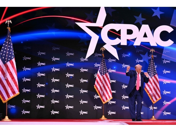 US President Donald Trump dances after speaking at the annual Conservative Political Action Conference (CPAC) in Oxon Hill, Maryland, on February 22, 2025. (Photo by Roberto Schmidt / AFP)