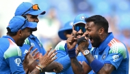 India's Hardik Pandya (R) celebrates with teammates after taking the wicket of Pakistan's Saud Shakeel during the ICC Champions Trophy one-day international (ODI) cricket match between Pakistan and India at the Dubai International Stadium in Dubai on February 23, 2025. (Photo by Jewel SAMAD / AFP)
