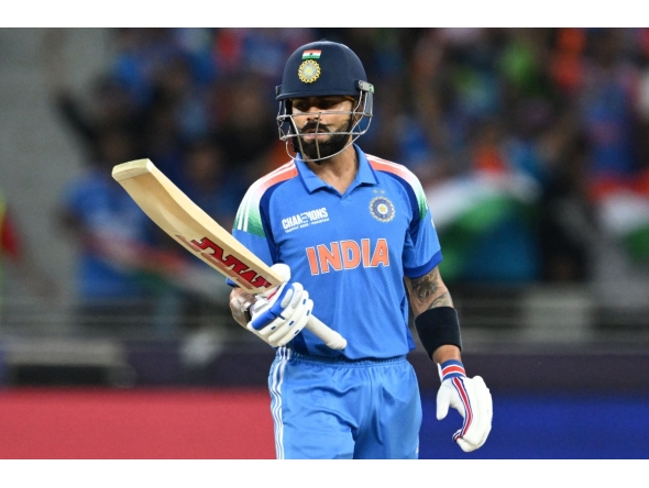 India's Virat Kohli looks at his bat during the ICC Champions Trophy one-day international (ODI) cricket match between Pakistan and India at the Dubai International Stadium in Dubai on February 23, 2025. (Photo by Jewel SAMAD / AFP)