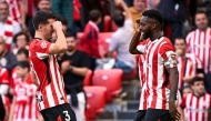 Athletic Bilbao's Spanish forward #09 Inaki Williams (R) celebrates with Athletic Bilbao's Spanish defender #04 Aitor Paredes after scoring their seventh goal during the Spanish league football match between Athletic Club Bilbao and Real Valladolid FC at San Mames Stadium in Bilbao on February 23, 2025. (Photo by ANDER GILLENEA / AFP)
