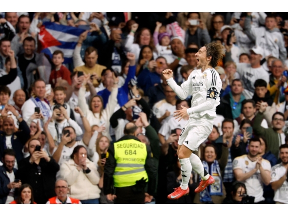 Real Madrid's Croatian midfielder #10 Luka Modric celebrates scoring the opening goal during the Spanish league football match between Real Madrid CF and Girona FC at Santiago Bernabeu Stadium in Madrid on February 23, 2025. (Photo by Pierre-Philippe Marcou / AFP)