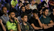 Pakistani cricket fans react as they watch a live broadcast of the ICC Champions Trophy one-day international (ODI) cricket match between India and Pakistan in Dubai, on a big screen in Karachi on February 23, 2025. (Photo by Asif Hassan / AFP)