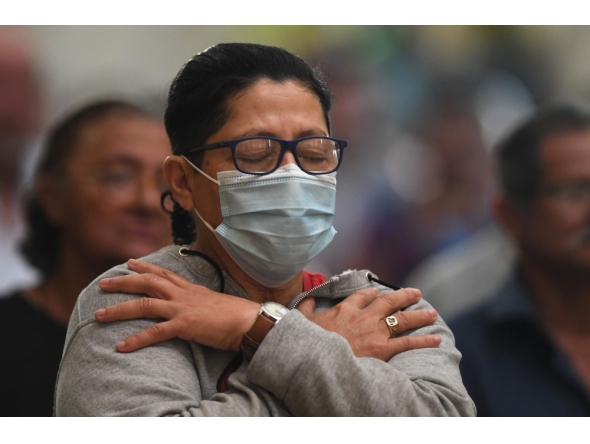 A catholic faithful prays during a mass for the healing of Pope Francis at San Miguel Arcangel Cathedral in Tegucigalpa on February 23, 2025. (Photo by Orlando Sierra / AFP)