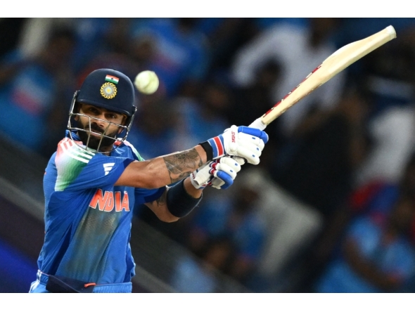 India's Virat Kohli hits the winning boundary and completes his century (100 runs) during the ICC Champions Trophy match between Pakistan and India in Dubai on February 23, 2025. (Photo by Jewel Samad / AFP)