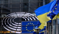 The European and Ukrainian flags are displayed in front of the Altiero-Spinelli building, the European Parliament in Brussels on February 24, 2025. (Photo by John Thys / AFP)